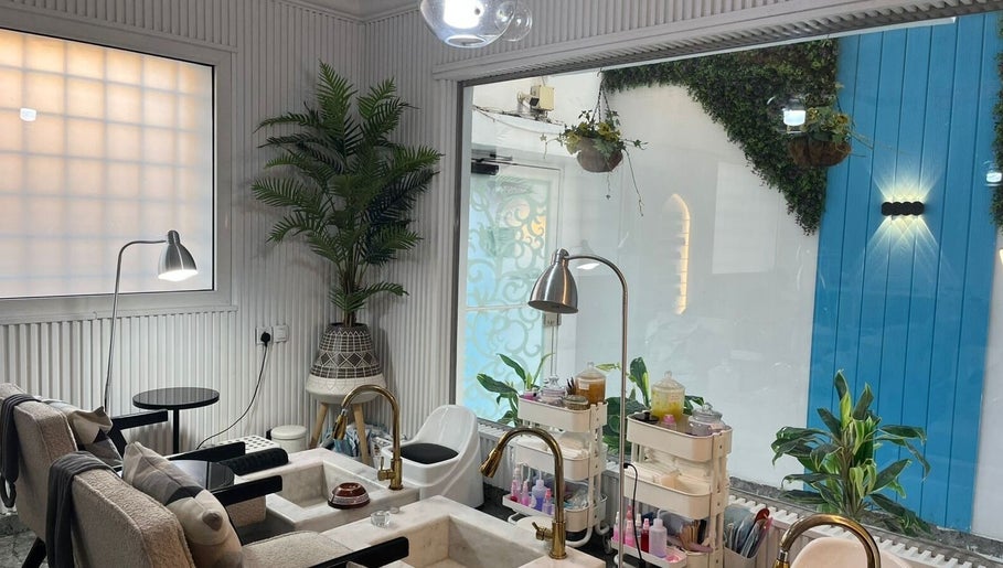 Relaxing pedicure area at Moon Spa, Dammam, Eastern Province, SA, featuring cozy chairs and lush greenery.