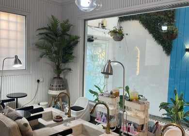 Relaxing pedicure area at Moon Spa, Dammam, Eastern Province, SA, featuring cozy chairs and lush greenery.