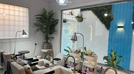 Relaxing pedicure area at Moon Spa, Dammam, Eastern Province, SA, featuring cozy chairs and lush greenery.