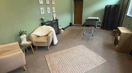 Calm therapy room at Dragonfly Counselling & Reiki, Hebburn, England, with chairs and a massage table.