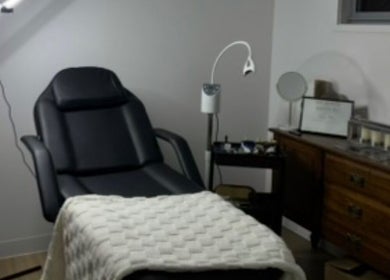 Cozy treatment room at Soulbi studio, Primbee, New South Wales, AU, featuring a comfortable recliner and soft lighting.