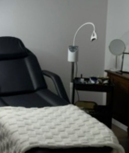 Cozy treatment room at Soulbi studio, Primbee, New South Wales, AU, featuring a comfortable recliner and soft lighting.