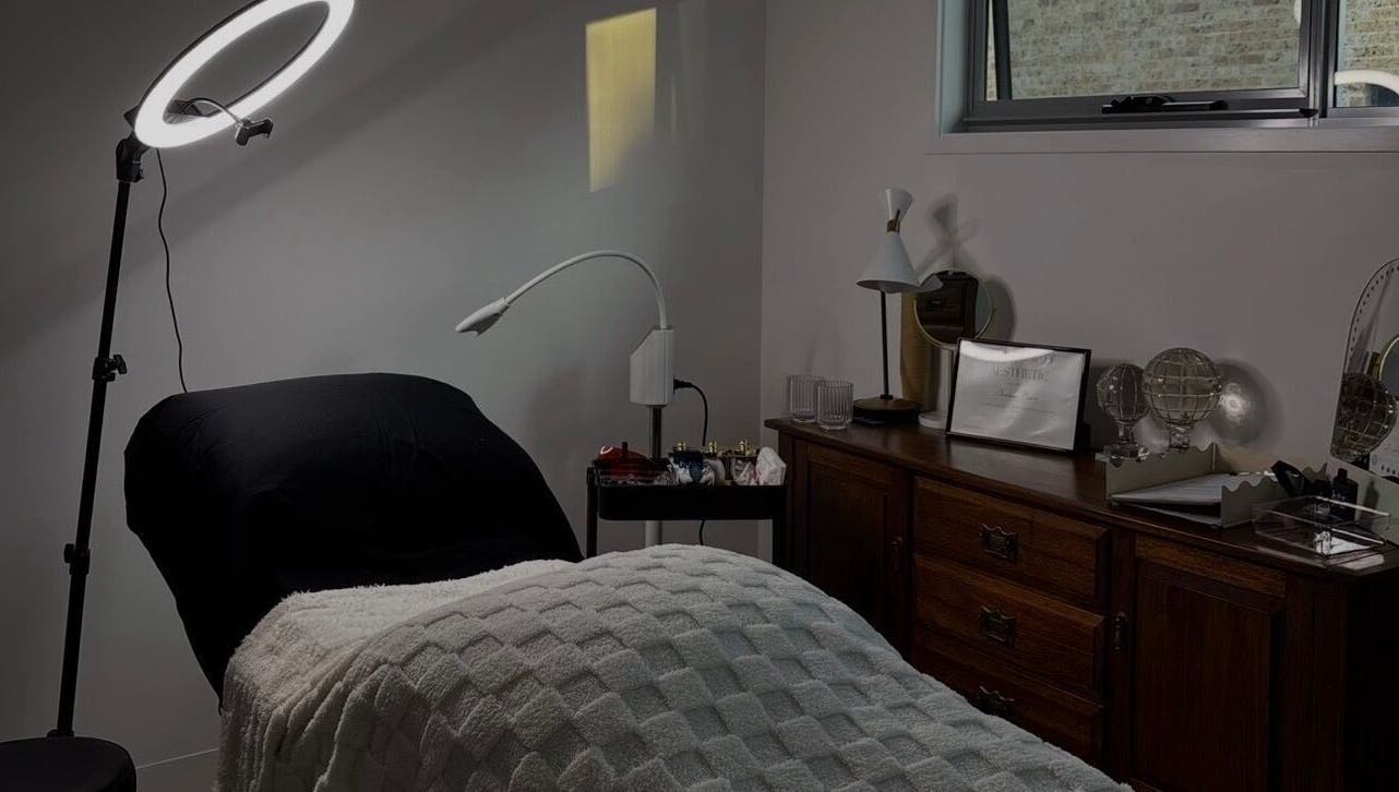 Cozy room at Soulbi studio in Primbee, New South Wales with massage bed, ring light, and elegant decor.