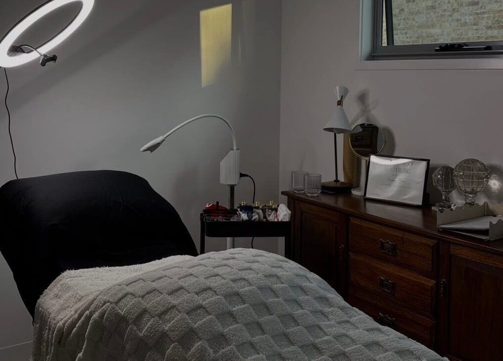 Cozy room at Soulbi studio in Primbee, New South Wales with massage bed, ring light, and elegant decor.