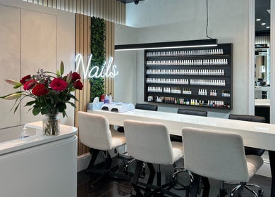 Elegant nail salon at Medivine, Birmingham, England, GB with a chic manicure station and vibrant floral decor.