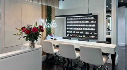 Elegant nail salon at Medivine, Birmingham, England, GB with a chic manicure station and vibrant floral decor.