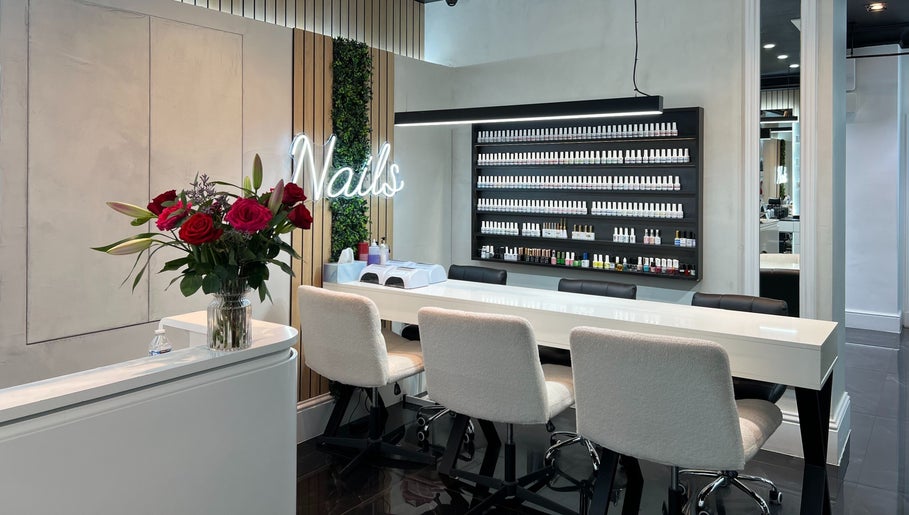 Beautiful nail bar at Medivine, Birmingham, England, GB with modern decor and lush floral arrangements.