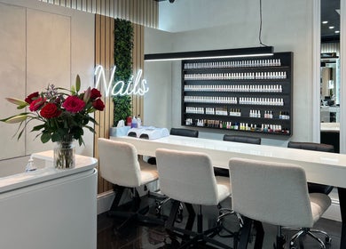 Beautiful nail bar at Medivine, Birmingham, England, GB with modern decor and lush floral arrangements.