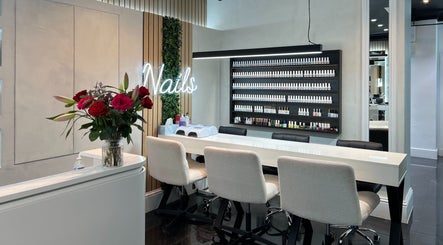 Beautiful nail bar at Medivine, Birmingham, England, GB with modern decor and lush floral arrangements.