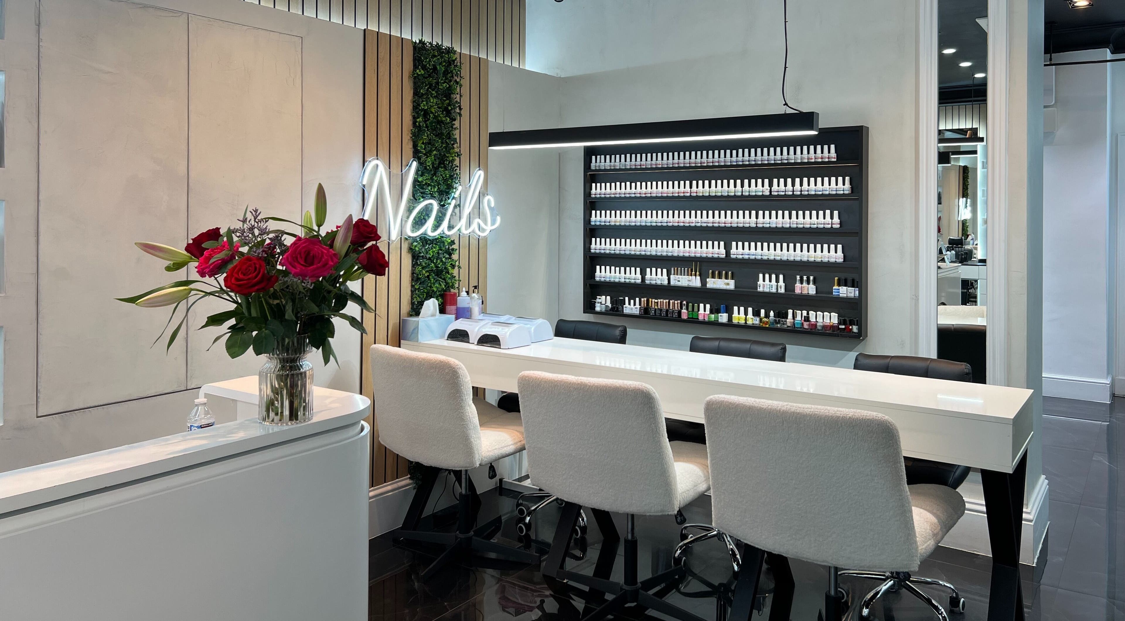 Beautiful nail bar at Medivine, Birmingham, England, GB with modern decor and lush floral arrangements.