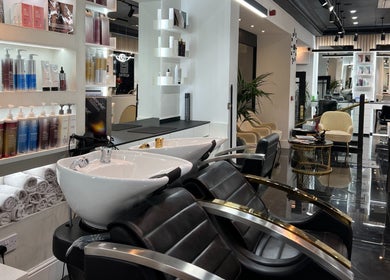 Modern salon interior at Medivine, Birmingham, England, showcasing stylish wash stations and luxury products.