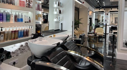 Modern salon interior at Medivine, Birmingham, England, showcasing stylish wash stations and luxury products.