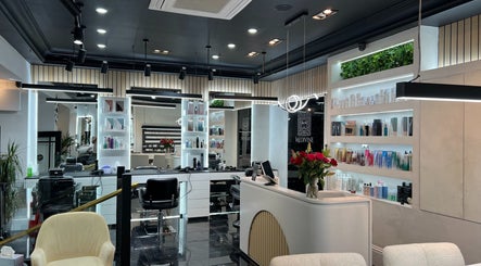 Chic interior of Medivine beauty salon in Birmingham, England, GB, showcasing styling stations and product displays.