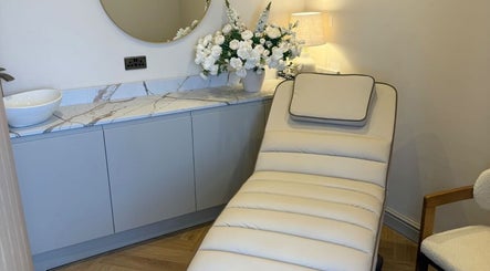 Relaxing lounge chair at Peak Wellness Health and Medispa, Dronfield, England, GB, near elegant countertop and mirror.