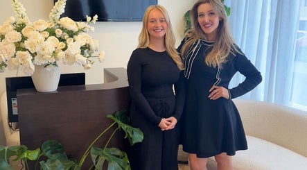 Welcoming team at Peak Wellness Health and Medispa, Dronfield, England, GB, with floral decor and friendly smiles.
