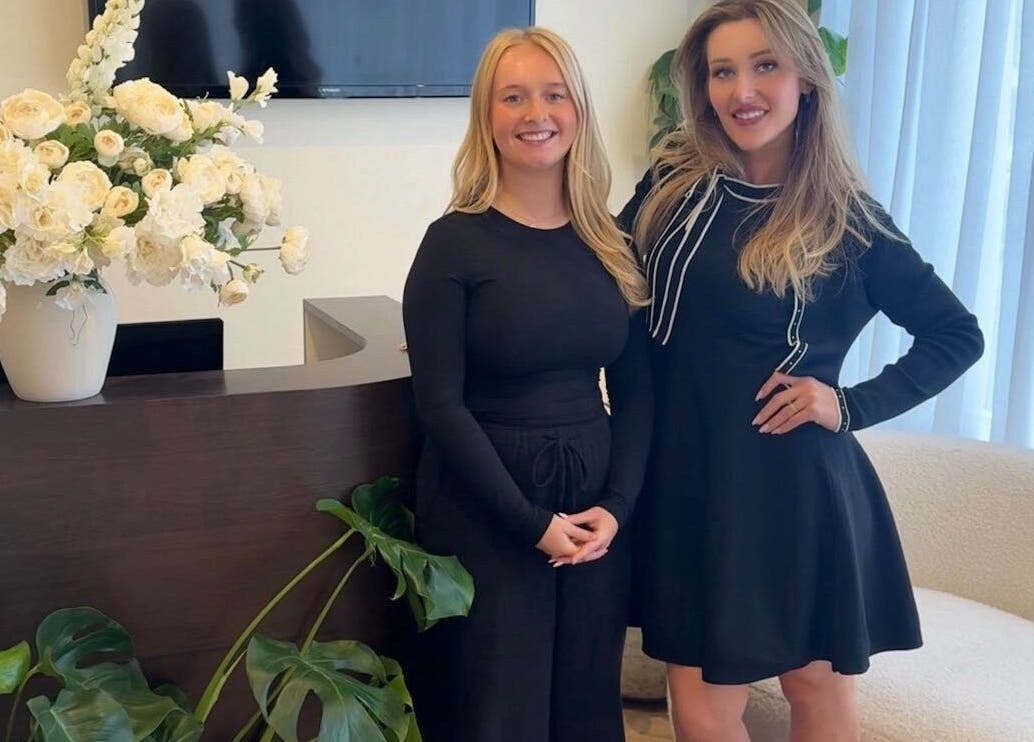 Friendly staff at Peak Wellness Health and Medispa, Dronfield, England, welcoming guests with vibrant floral decor.