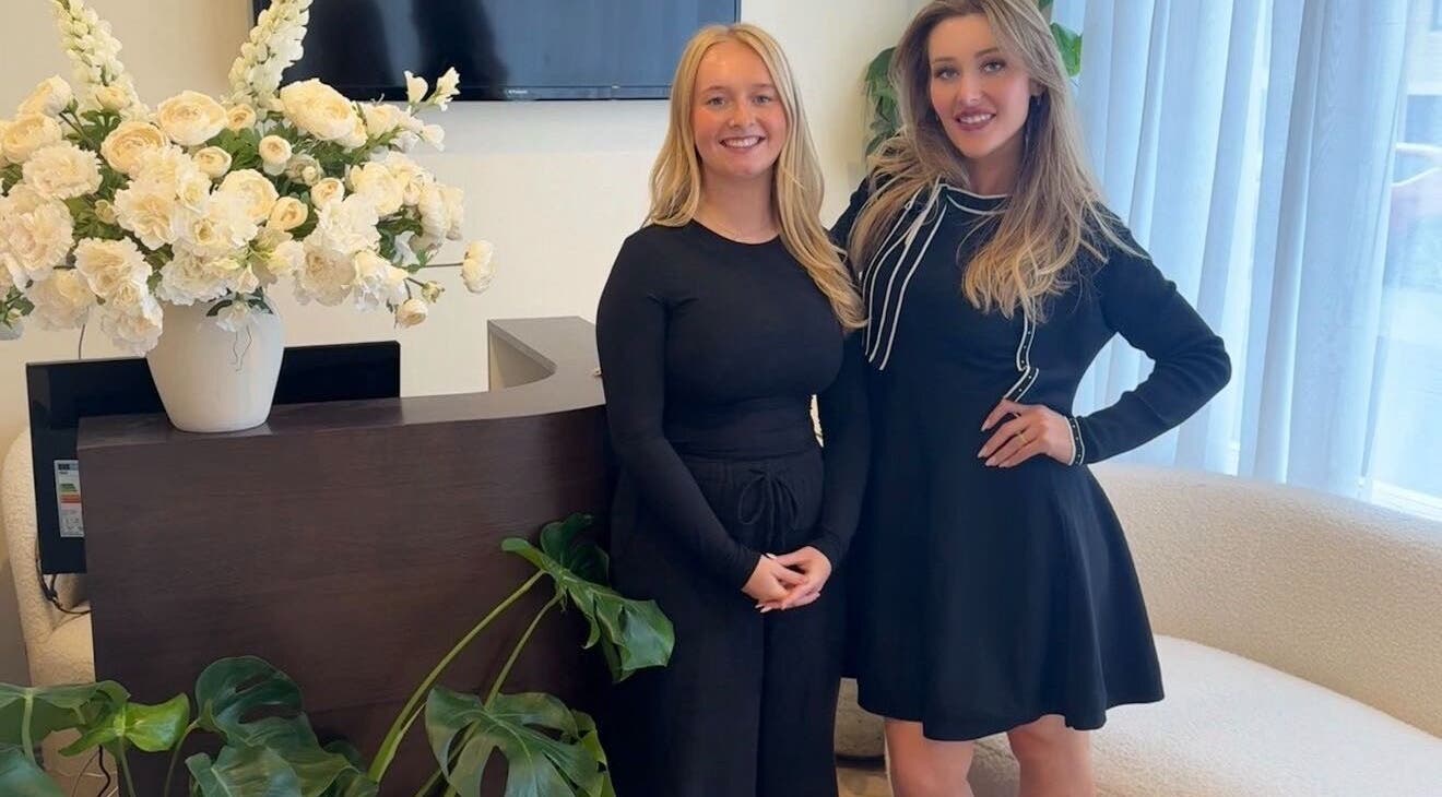 Friendly staff at Peak Wellness Health and Medispa, Dronfield, England, welcoming guests with vibrant floral decor.