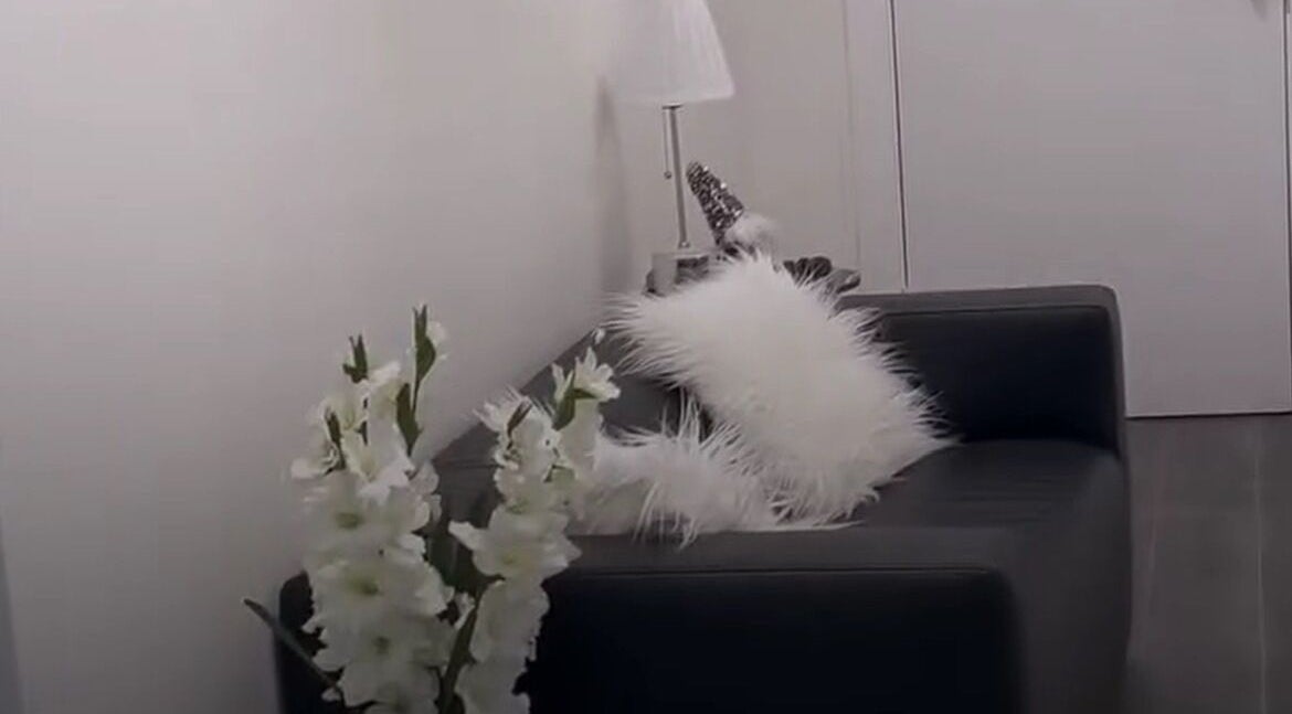 Relaxing seating at The Nail Nest by Shannen, Limerick, County Limerick, IE with white pillows and flowers.