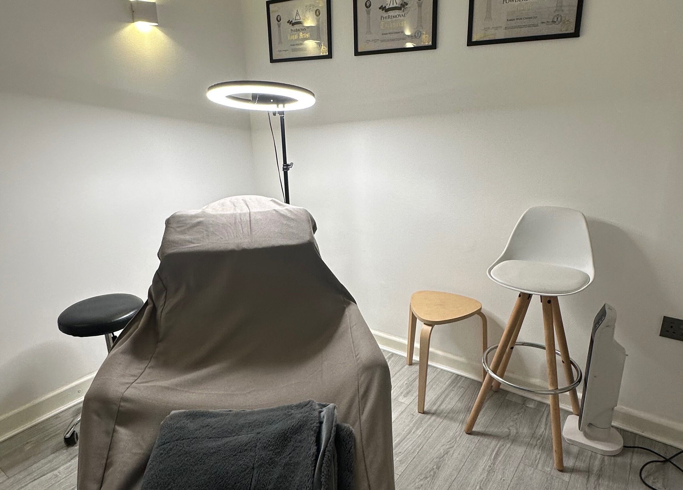 Cozy treatment room at Thy Beauty Studio, Solihull, England, GB, featuring a comfortable chair and soft lighting.