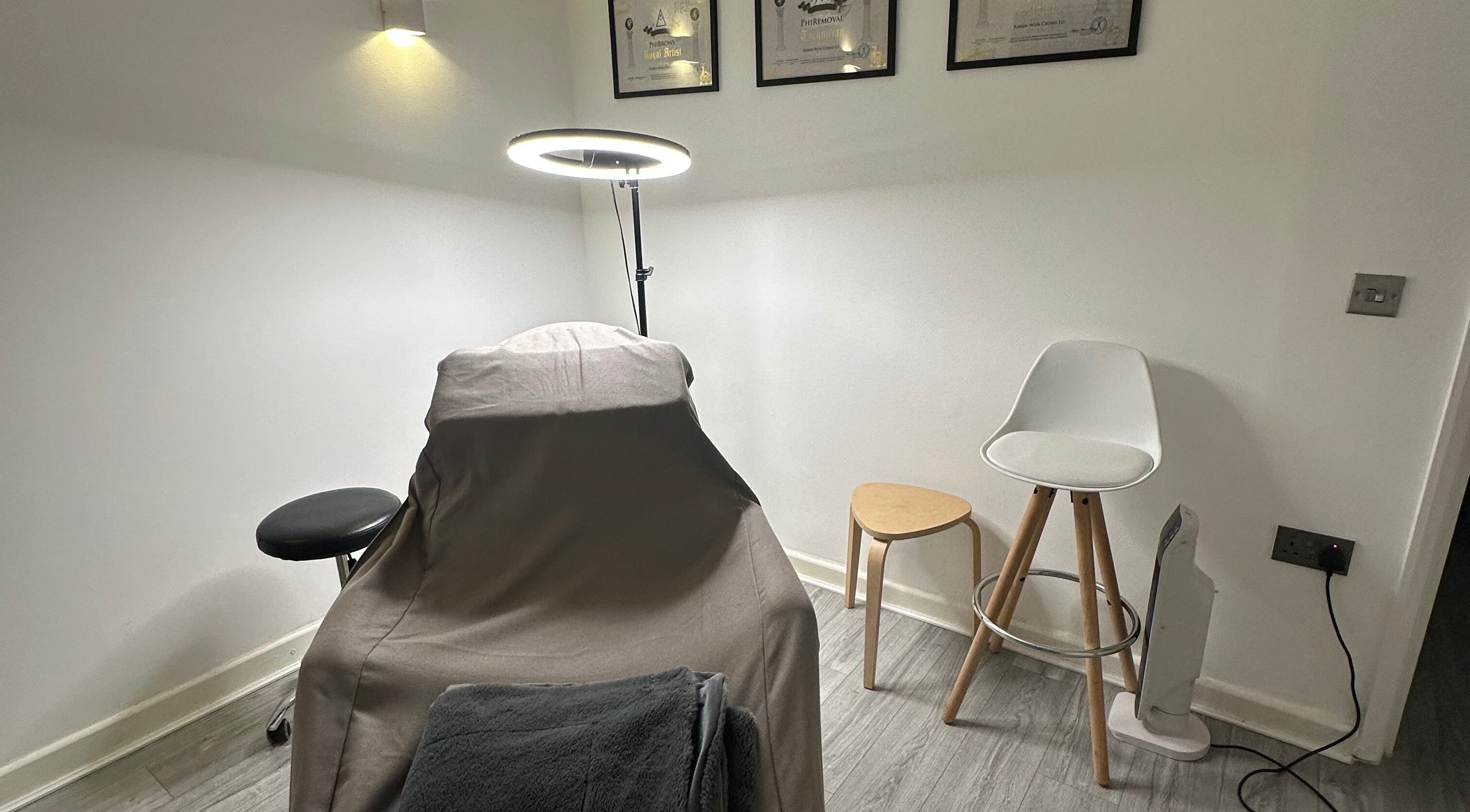Cozy treatment room at Thy Beauty Studio, Solihull, England, GB, featuring a comfortable chair and soft lighting.