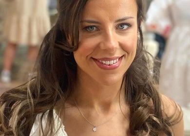 Smiling woman with styled hair, showcasing Mobile Makeup Artistry by Sarah in Edinburgh, Scotland, GB.