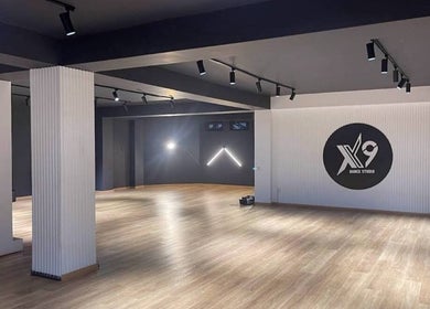 Spacious interior of Xnine Dance Studio Pilates in T'bilisi, Tbilisi, GE with modern lighting and wooden floors.