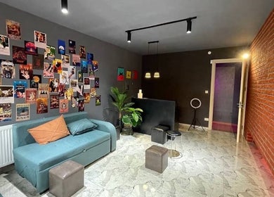 Cozy lounge area at Xnine Dance Studio Pilates, T'bilisi, Tbilisi, GE with art-covered walls and modern seating.