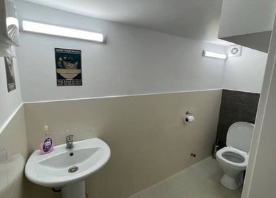 Modern restroom at Xnine Dance Studio Pilates in T'bilisi, Tbilisi, GE, featuring a sink and toilet.