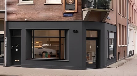 Exterior of Artist Lab in Amsterdam, Noord-Holland, NL features a sleek black facade and large display windows.