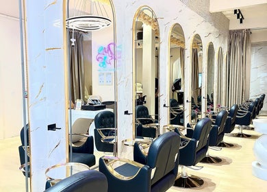 Chic interior of De boss hair & nail saloon in Johor Bahru, Johor Darul Ta'zim, MY with stylish chairs and mirrors.