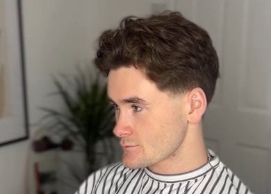Man with trendy haircut at Solo Chair, Royal Leamington Spa, England, GB.