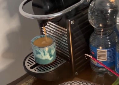 Nespresso machine brewing coffee at Solo Chair, Royal Leamington Spa, England, GB. Relaxing ambiance.