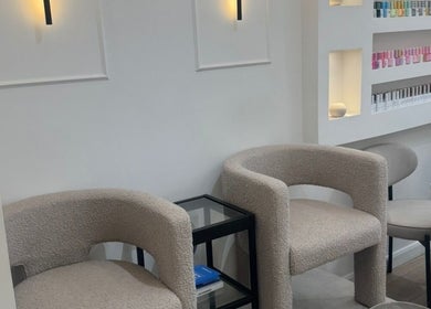 Modern interior of Reset Beauty, London, England, GB, featuring chic chairs and nail polish display.