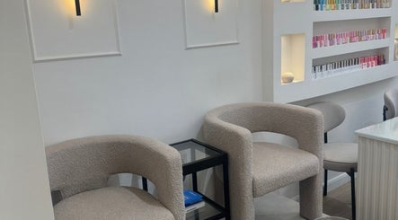 Modern interior of Reset Beauty, London, England, GB, featuring chic chairs and nail polish display.