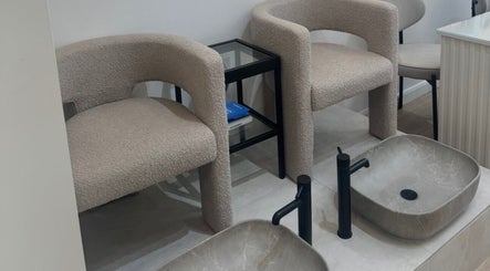 Modern pedicure chairs and basins at Reset Beauty, London, England, GB. Relaxing and stylish spa setting.