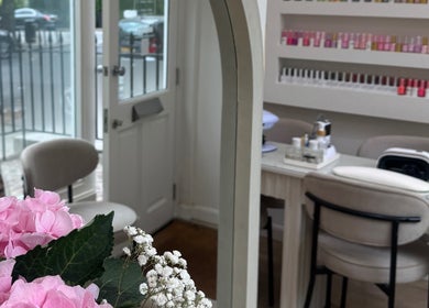Elegant manicure station with pink flowers at Reset Beauty, London, England, GB. Luxurious and inviting space.