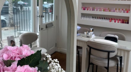 Elegant manicure station with pink flowers at Reset Beauty, London, England, GB. Luxurious and inviting space.