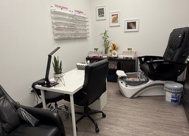 Chic manicure station at Artistry Nails Miami, Plantation, Florida, US with nail polish display and sleek chairs.