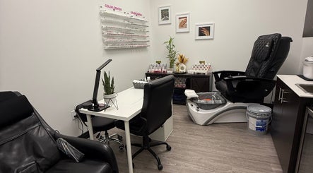 Chic manicure station at Artistry Nails Miami, Plantation, Florida, US with nail polish display and sleek chairs.