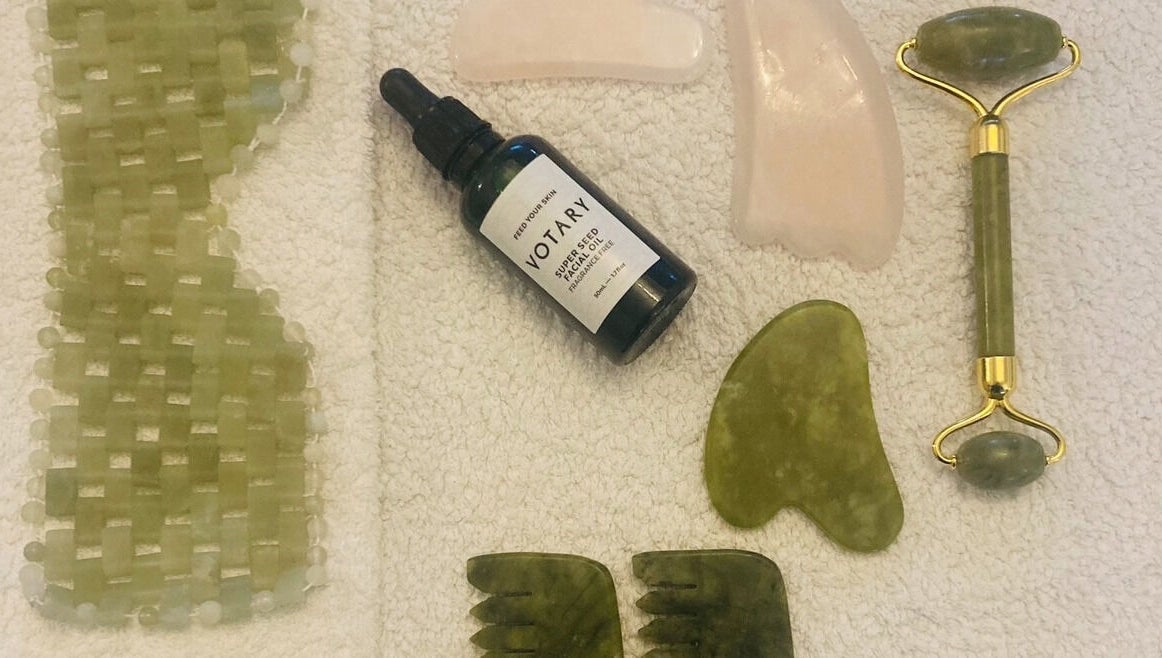 Skincare tools set at Skincare Studio Uk, Saffron Walden, England, GB, featuring jade roller and facial oil.