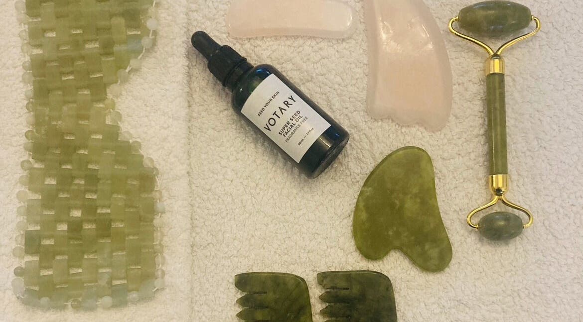 Skincare tools set at Skincare Studio Uk, Saffron Walden, England, GB, featuring jade roller and facial oil.