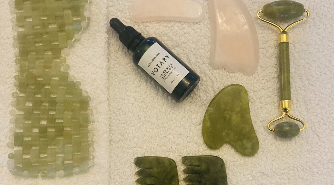 Skincare tools set at Skincare Studio Uk, Saffron Walden, England, GB, featuring jade roller and facial oil.
