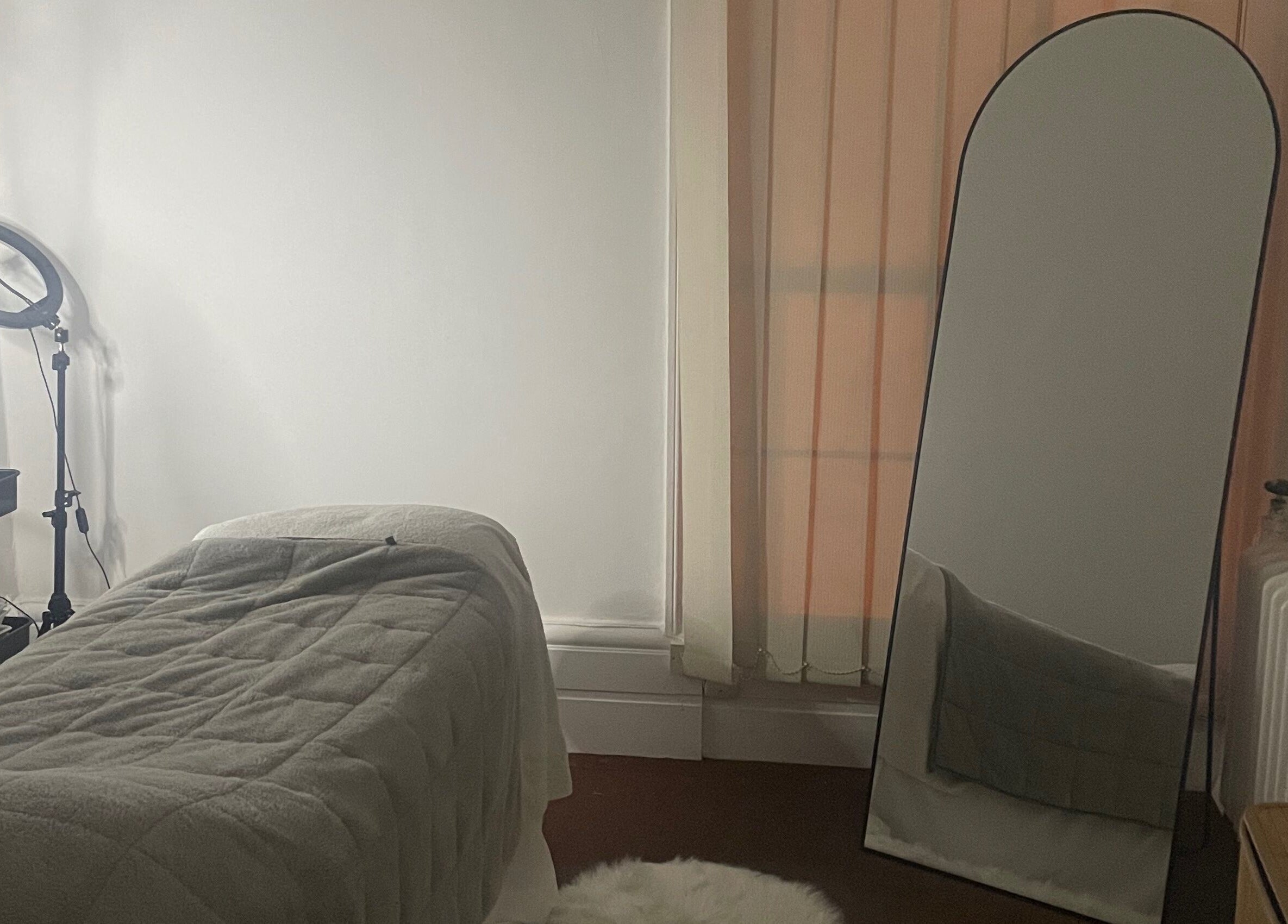 Cozy treatment room at Skincare Studio Uk, Saffron Walden, England, GB with a massage table and mirror.