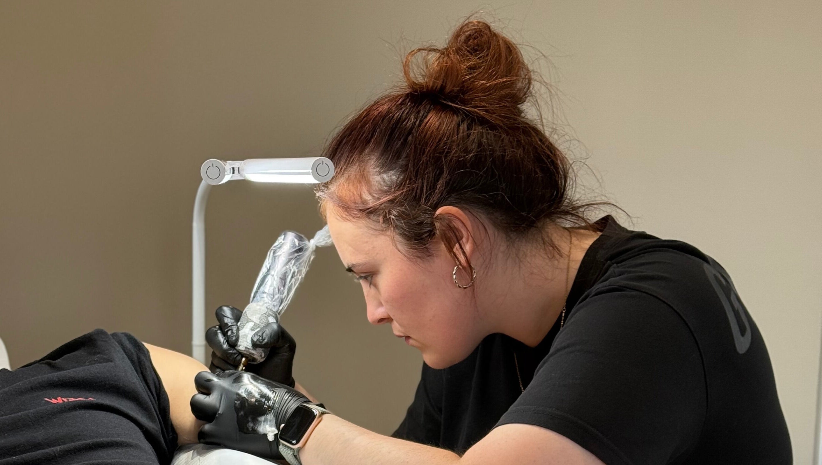 Artist working on a tattoo at Ash Fern Tattoo, Romford, England, GB, showcasing precision and detail.