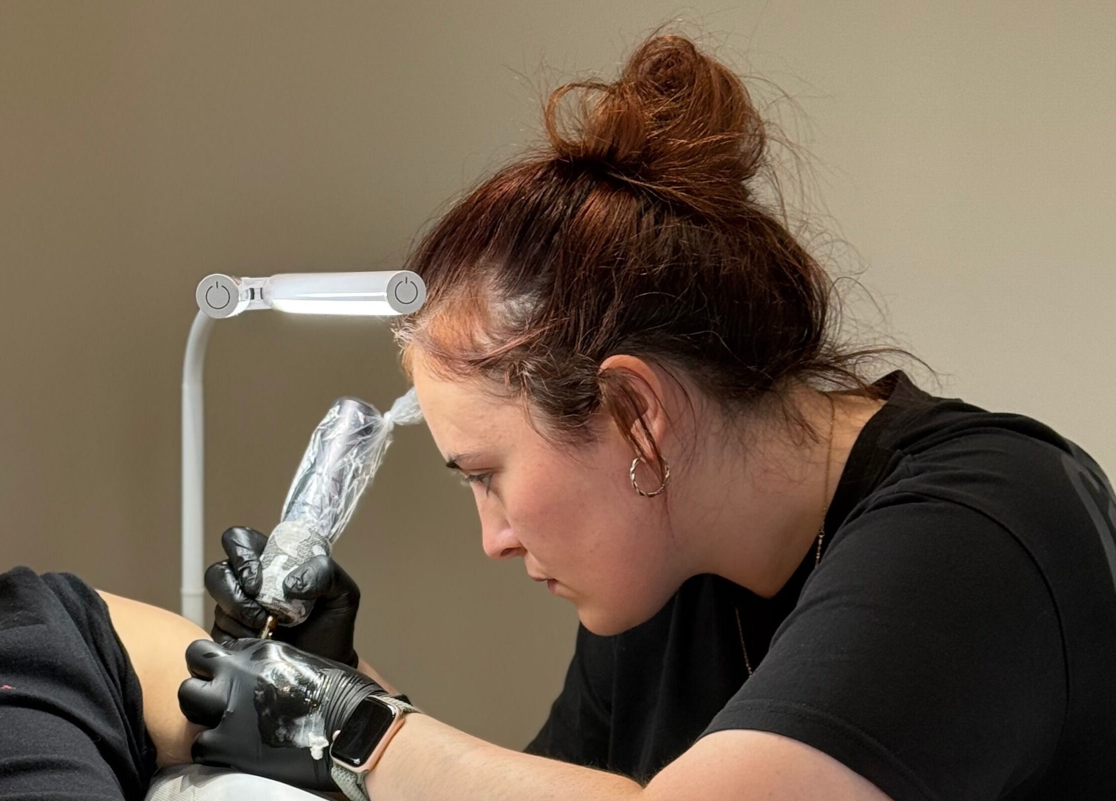 Artist working on a tattoo at Ash Fern Tattoo, Romford, England, GB, showcasing precision and detail.