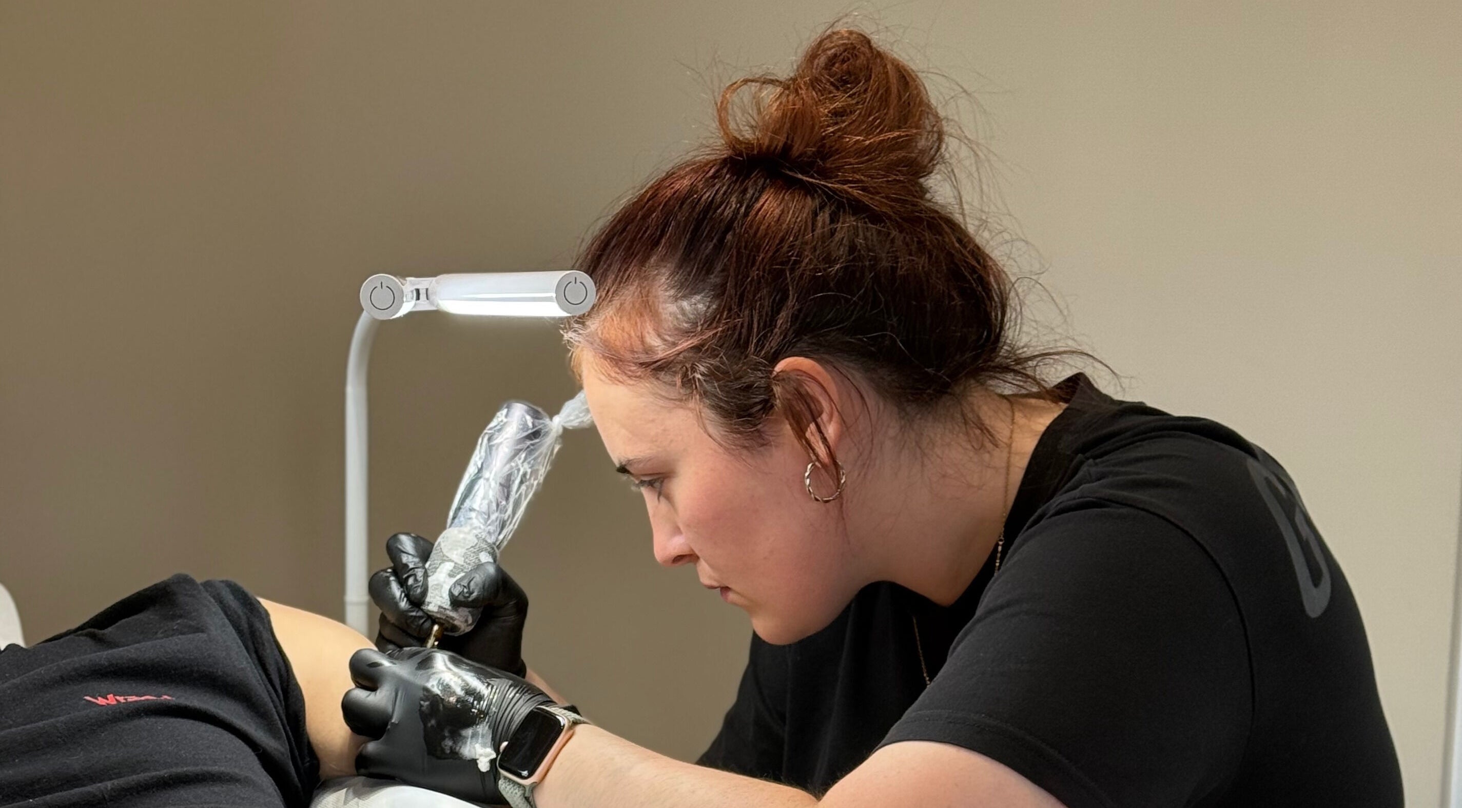 Artist working on a tattoo at Ash Fern Tattoo, Romford, England, GB, showcasing precision and detail.