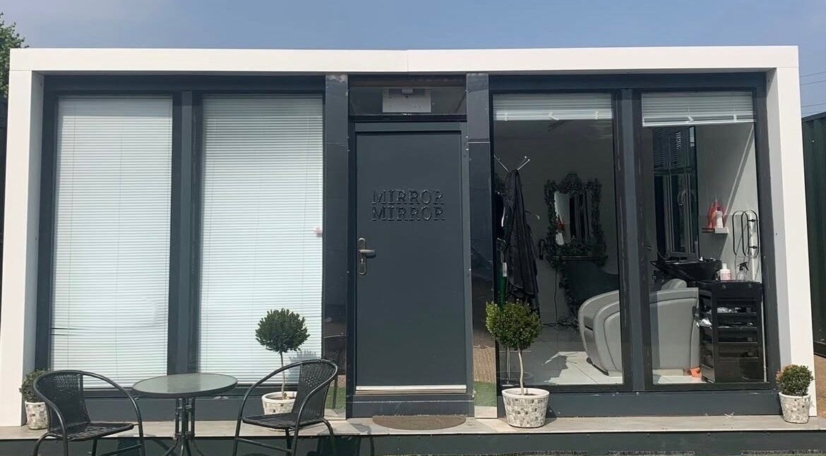 Modern storefront of Ash Fern Tattoo in Romford, England, GB, with a stylish salon and greenery.