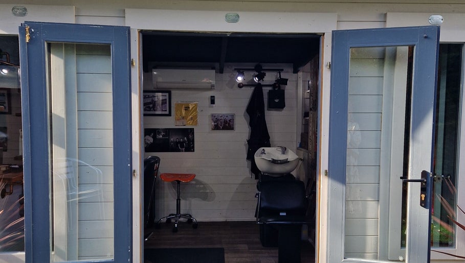 The Garden Salon Hair Design's open door showcases a cozy interior in Colchester, England, GB.