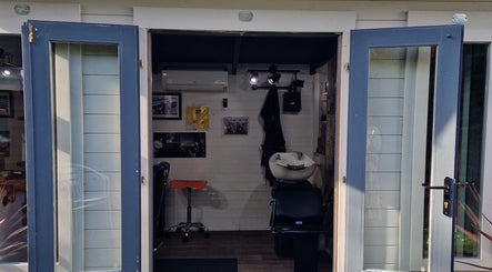 The Garden Salon Hair Design's open door showcases a cozy interior in Colchester, England, GB.