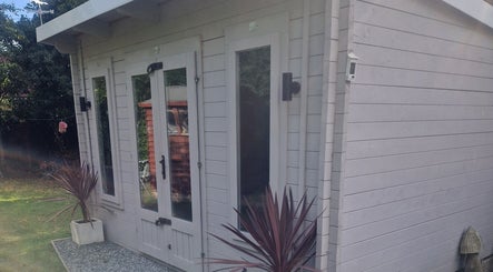 Elegant exterior of The Garden Salon Hair Design in Colchester, England, GB with modern wooden decor.